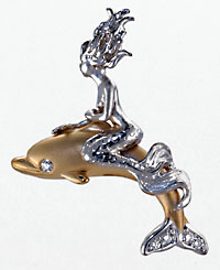 white gold mermaid riding atop a 14kt gold dolphin with diamonds